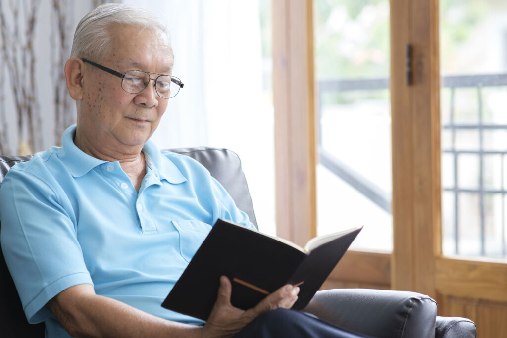 senior-man-reading-book-and-stay-alone-at-home